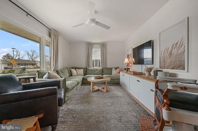 living room with ceiling fan and a healthy amount of sunlight