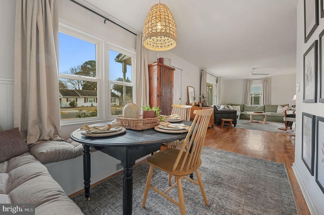 dining area featuring ceiling fan and dark wood-type flooring