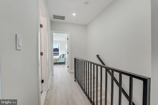 corridor with light hardwood / wood-style floors