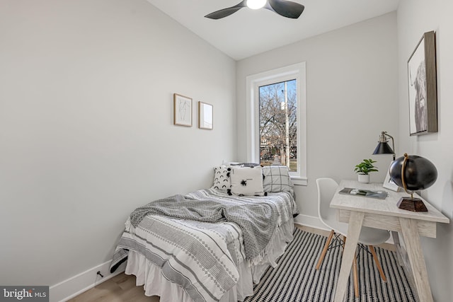 bedroom with light hardwood / wood-style floors, ceiling fan, and lofted ceiling