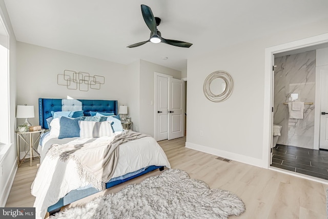 bedroom with light hardwood / wood-style floors, ensuite bath, and ceiling fan