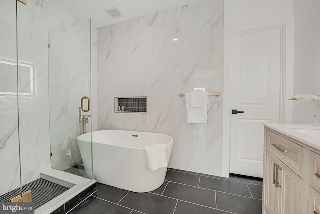 bathroom featuring tile patterned flooring, vanity, and shower with separate bathtub