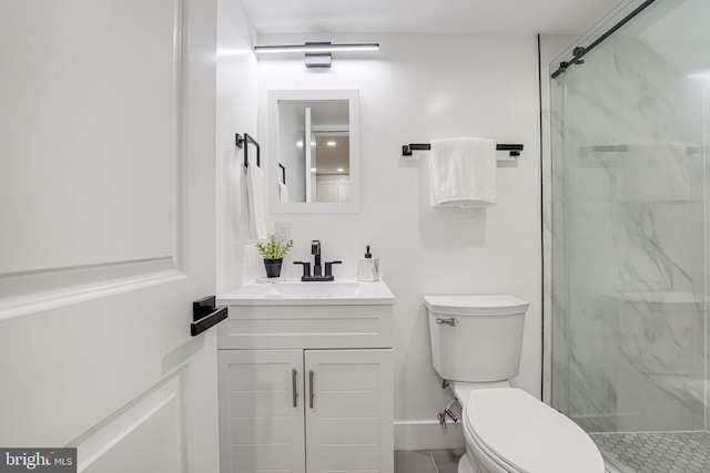 bathroom with vanity, a shower with shower door, and toilet