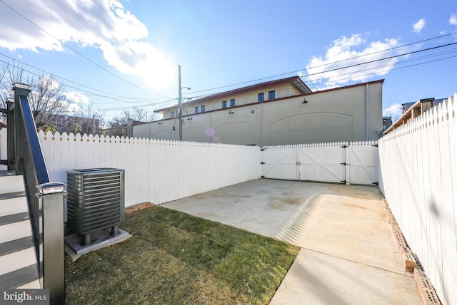 view of yard featuring central AC unit and a patio area