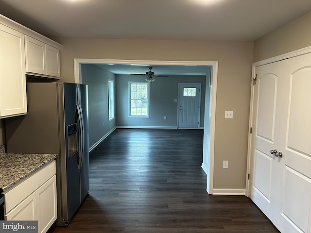 kitchen featuring white cabinets, stainless steel refrigerator with ice dispenser, ceiling fan, dark hardwood / wood-style floors, and light stone counters