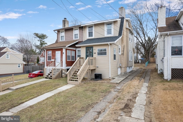 view of front facade featuring cooling unit and a front yard