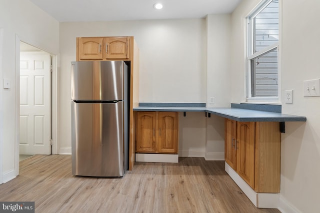 kitchen featuring light hardwood / wood-style floors and stainless steel refrigerator