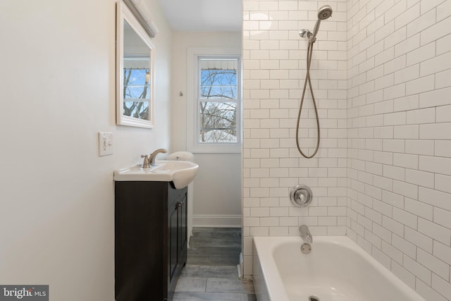 bathroom with vanity and tiled shower / bath