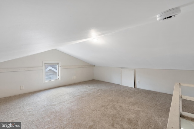 bonus room with carpet and lofted ceiling