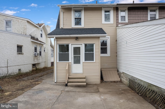 doorway to property with cooling unit and a patio area