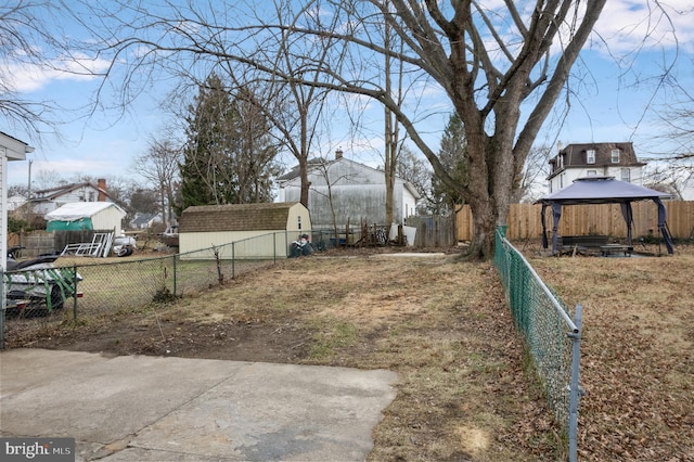 view of yard with a gazebo and a storage unit