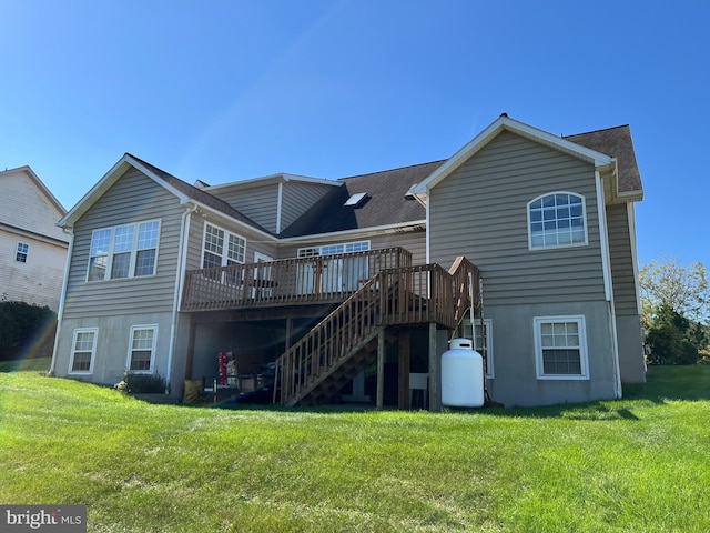 back of house featuring a deck and a yard