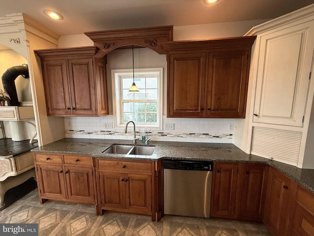 kitchen featuring backsplash, sink, stainless steel dishwasher, and decorative light fixtures