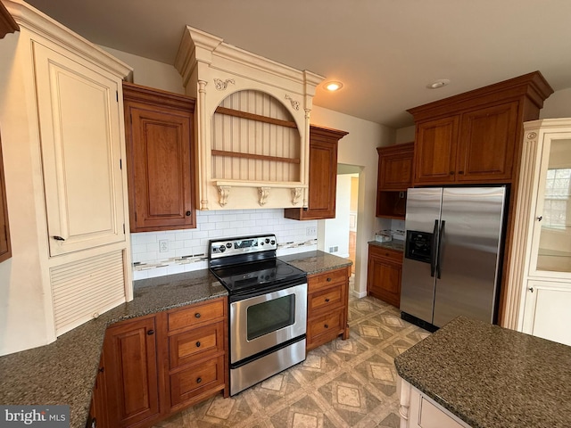 kitchen with appliances with stainless steel finishes and tasteful backsplash