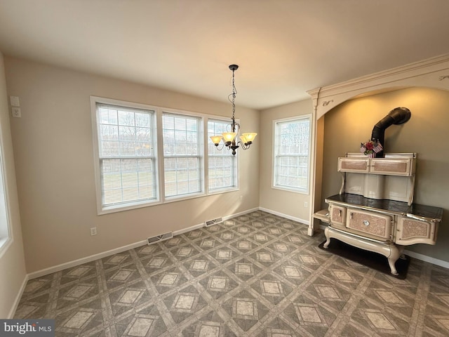 dining space featuring plenty of natural light and an inviting chandelier