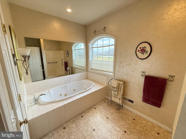 bathroom featuring tiled tub