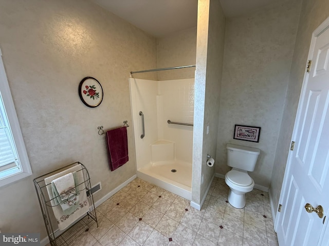 bathroom with heating unit, toilet, and walk in shower