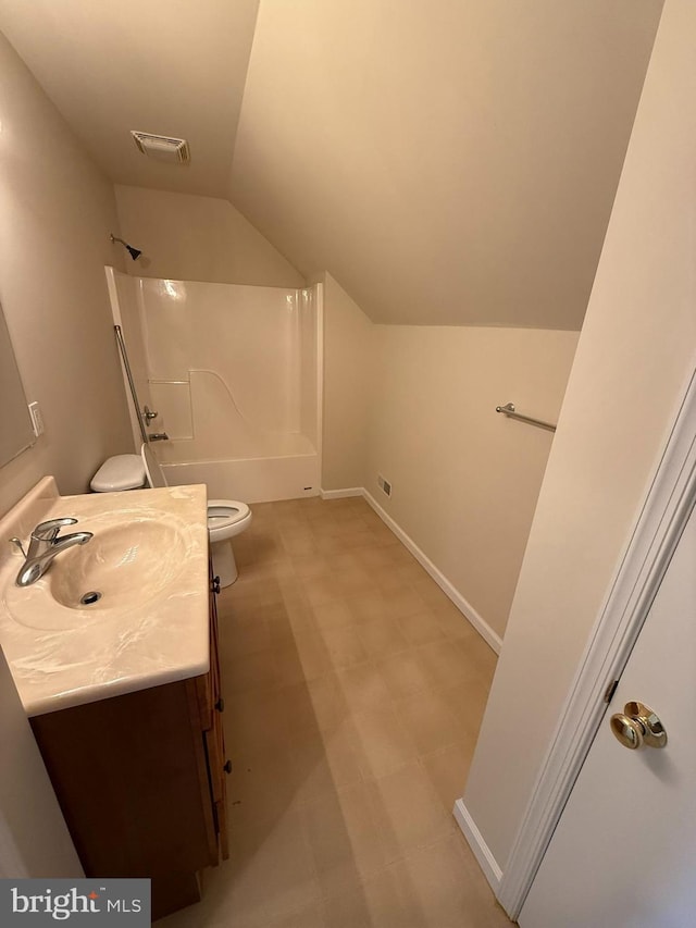 bathroom with vanity, toilet, and lofted ceiling