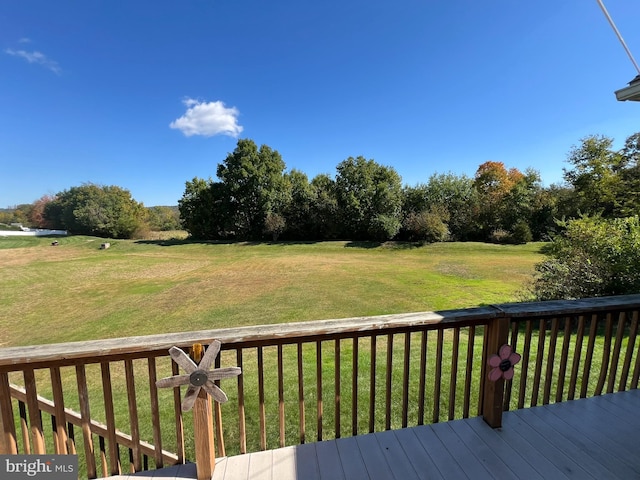 wooden terrace with a lawn