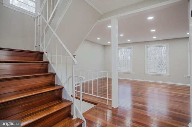 stairway with hardwood / wood-style flooring and a wealth of natural light