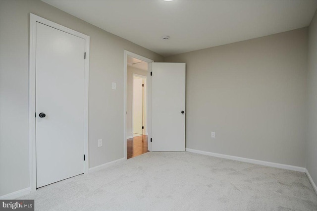 unfurnished bedroom featuring light carpet