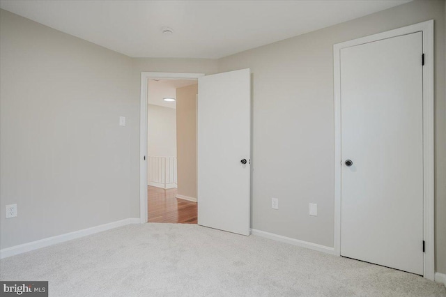 unfurnished bedroom with light colored carpet