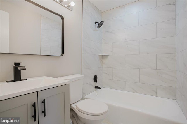 full bathroom featuring tiled shower / bath combo, toilet, and vanity