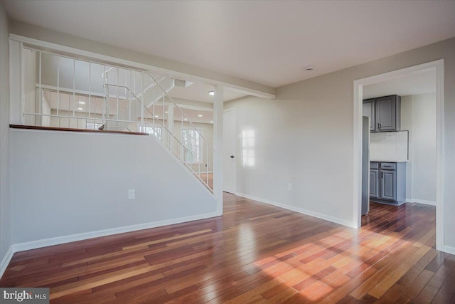 unfurnished living room featuring dark wood-type flooring