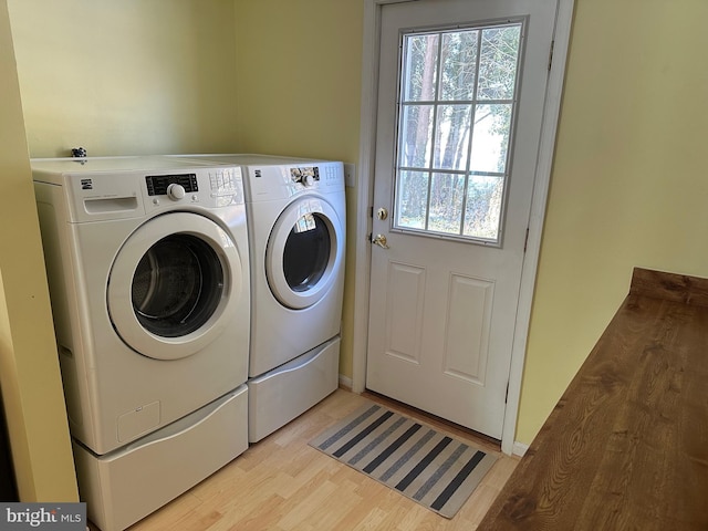 washroom featuring separate washer and dryer and light hardwood / wood-style flooring