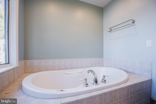 bathroom with a relaxing tiled tub