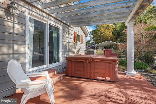 view of patio / terrace featuring a hot tub and a pergola