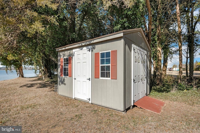 view of outbuilding with a yard