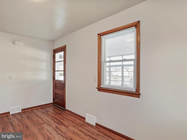 unfurnished room with hardwood / wood-style floors