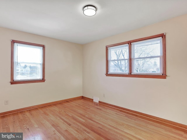 spare room featuring light hardwood / wood-style flooring