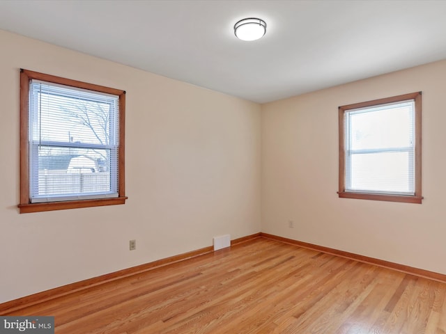 empty room with light hardwood / wood-style floors