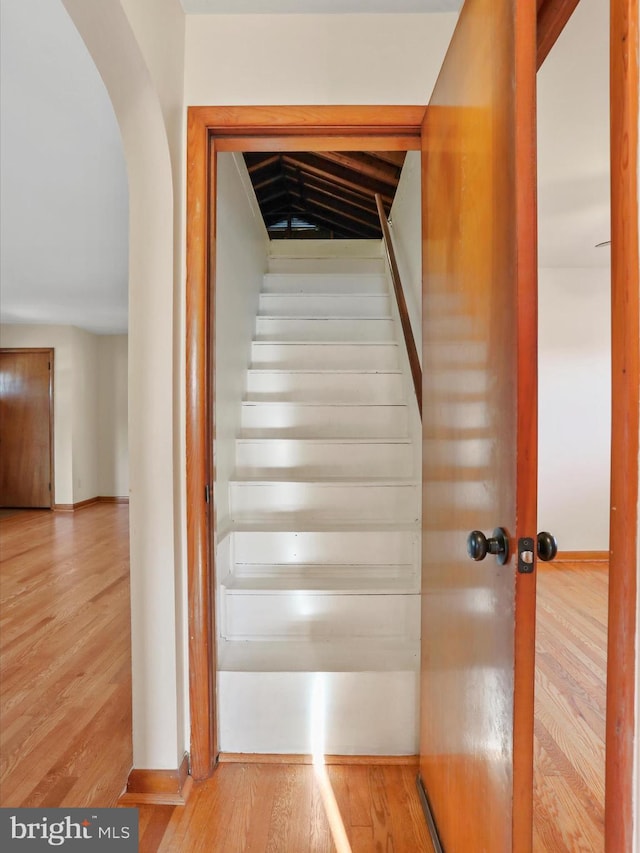 stairs with hardwood / wood-style floors