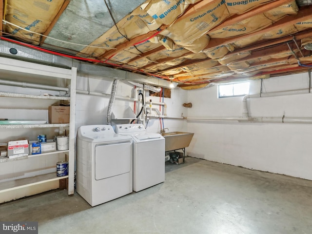 laundry area with independent washer and dryer and sink