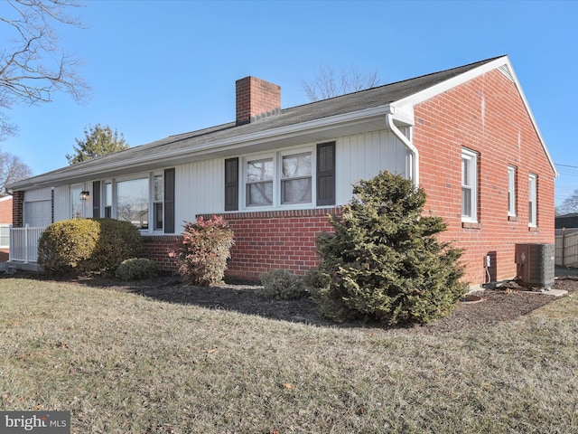 view of front of home featuring a front lawn and central air condition unit