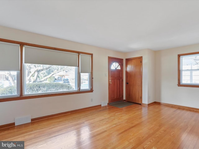 foyer entrance with light hardwood / wood-style floors