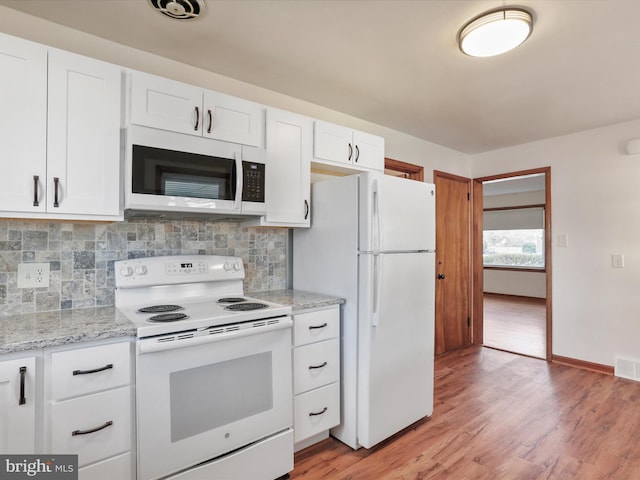 kitchen with white cabinetry, backsplash, white appliances, and light wood-type flooring