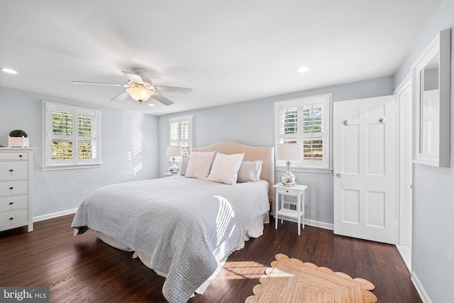 bedroom with dark hardwood / wood-style floors and ceiling fan