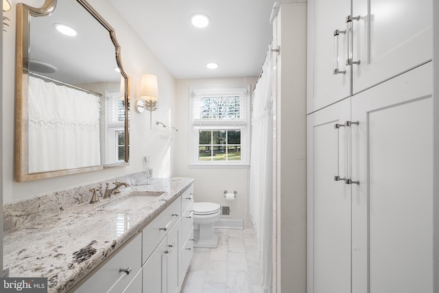 bathroom featuring vanity and toilet