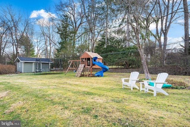 view of yard with a trampoline and a playground