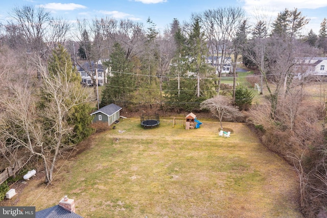 view of yard with a playground and a trampoline