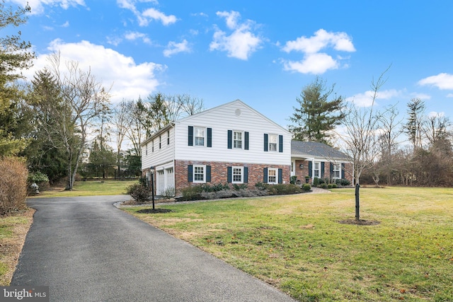 view of front of house with a front lawn and a garage