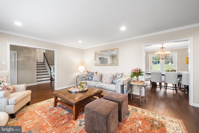 living room with an inviting chandelier, crown molding, and dark wood-type flooring