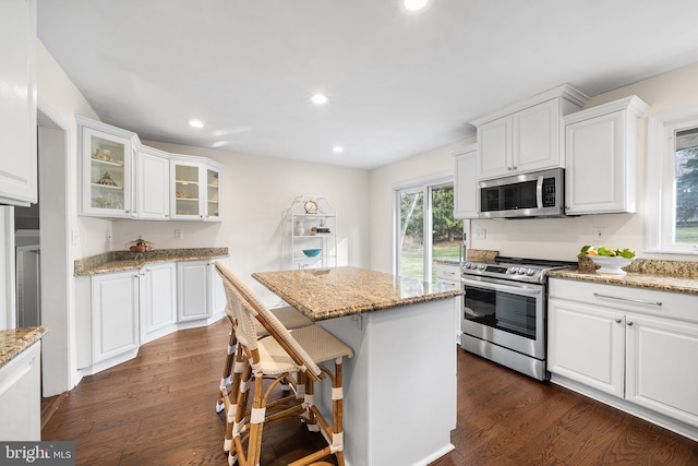 kitchen featuring white cabinetry, stainless steel appliances, and dark wood-type flooring