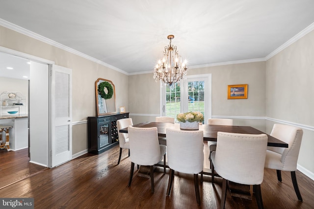 dining room featuring dark hardwood / wood-style flooring, an inviting chandelier, and ornamental molding