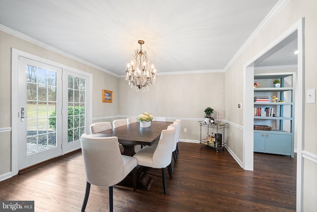 dining room featuring built in features, dark hardwood / wood-style floors, crown molding, and a notable chandelier