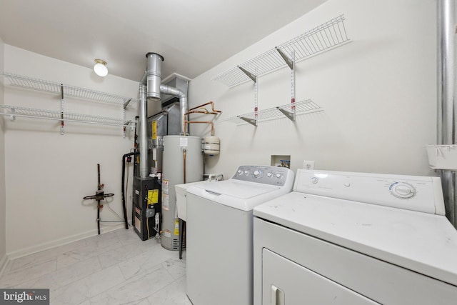 laundry area with gas water heater and washer and clothes dryer